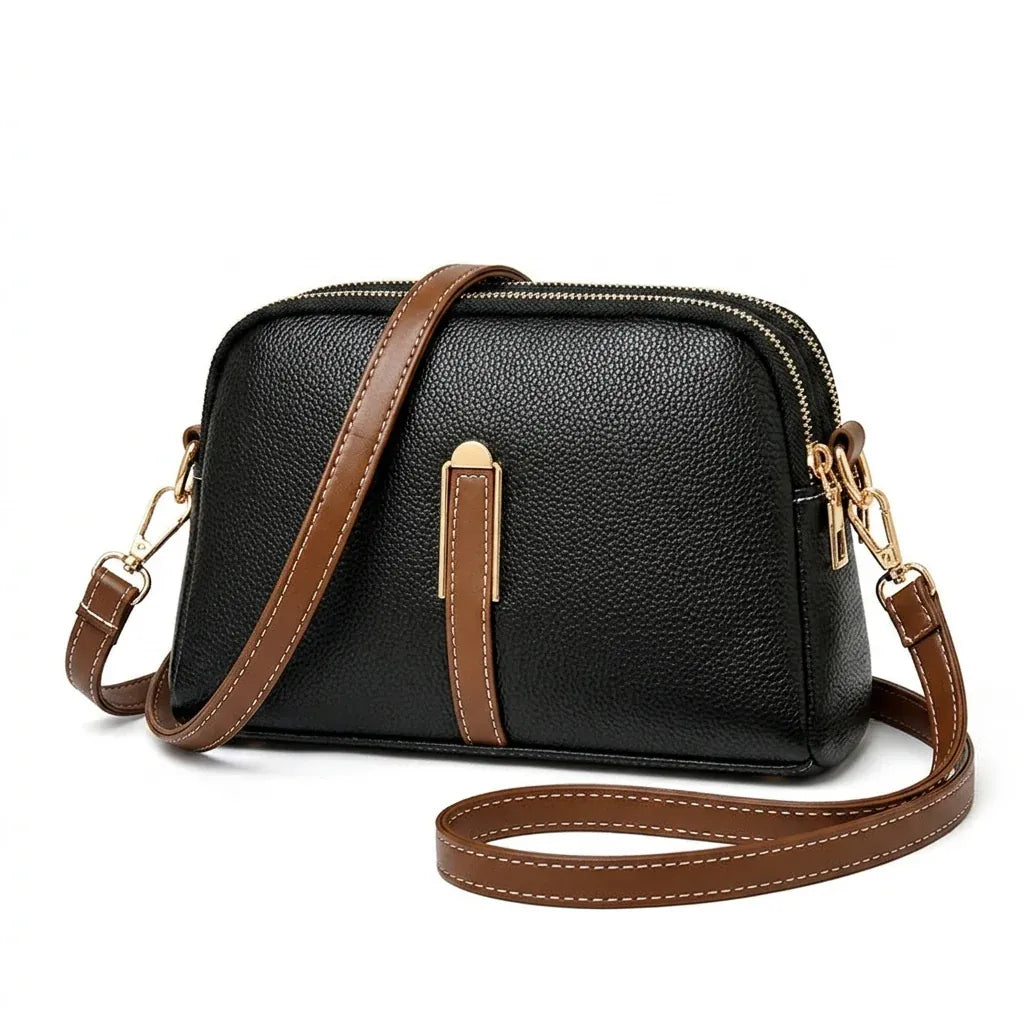 Rosny-sous-Bois - Sac bandoulière forme coquille, ligne urbaine - packshot sur fond blanc, coloris noir et cognac