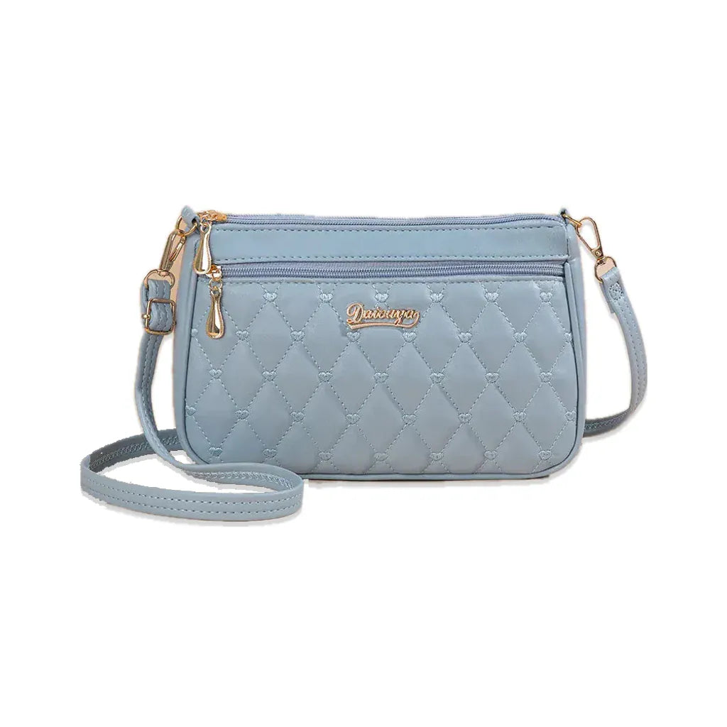 Suresnes - petit sac bandoulière matelassé bleu clair, vue de face sur fond blanc avec ombre douce